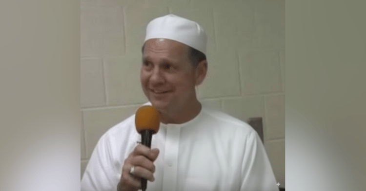 Roy Moore speaking into a microphone, despite past constitutional violations and removal from office