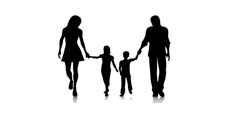 Silhouette of two adults and two children holding hands while walking forward against a white background with faint reflections