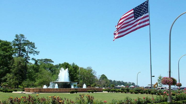 Fairhope, Alabama: American flag waves over a fountain in downtown area, celebrating approved BP RESTORE project funding