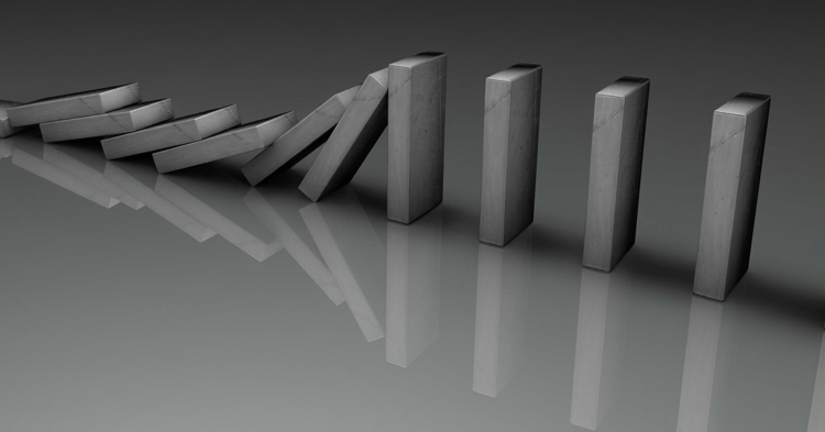 A row of gray dominoes falling from left to right on a reflective surface