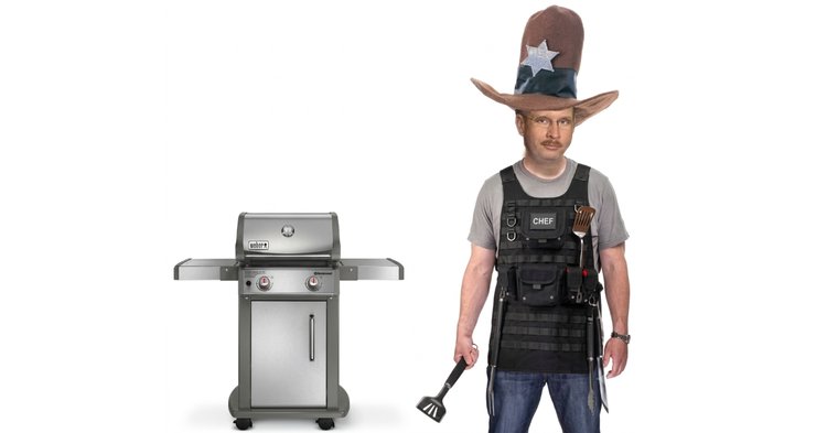 Hoss Mack in a cowboy hat & tactical gear holds spatula next to a grill.