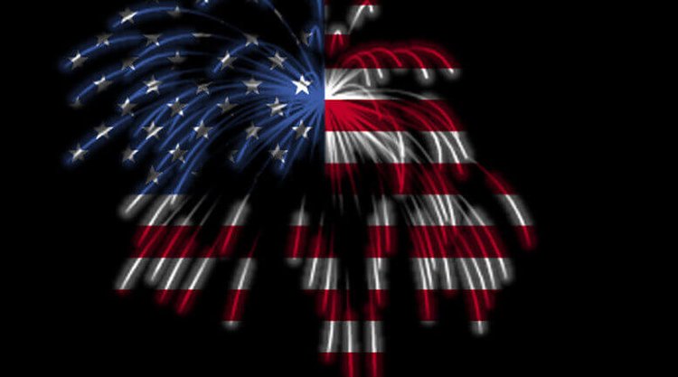 Fireworks exploding in the shape of an American flag against a black background, symbolizing patriotism and national celeb...