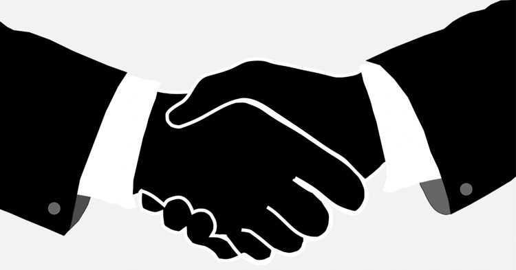 Two black silhouetted hands shaking in a handshake, wearing suit sleeves with white cuffs and visible buttons