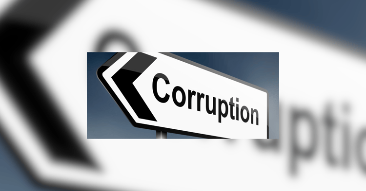 A white directional road sign with a black border points left, displaying the word Corruption in bold letters against a blurred blue sky