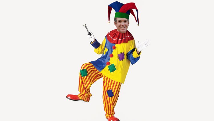 A person in a colorful jester costume with striped pants and a multi-colored hat stands against a white background, holding an object in one hand