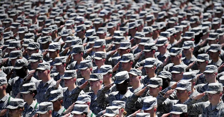 Veterans salute during a ceremony, honoring their courage and commitment on Veterans Day
