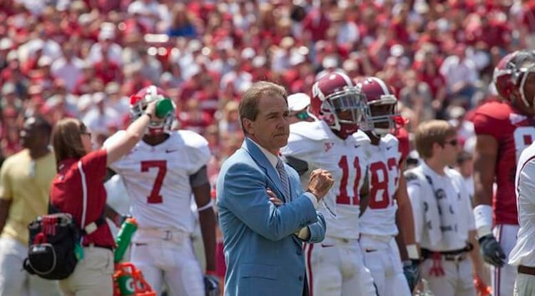 Nick Saban, coach of the Alabama Crimson Tide football team, stands on the sidelines during a game